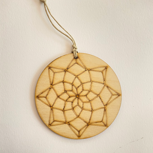 Wooden Color your own ornament. Circular shape with a design resembling a dream catcher or stained glass window