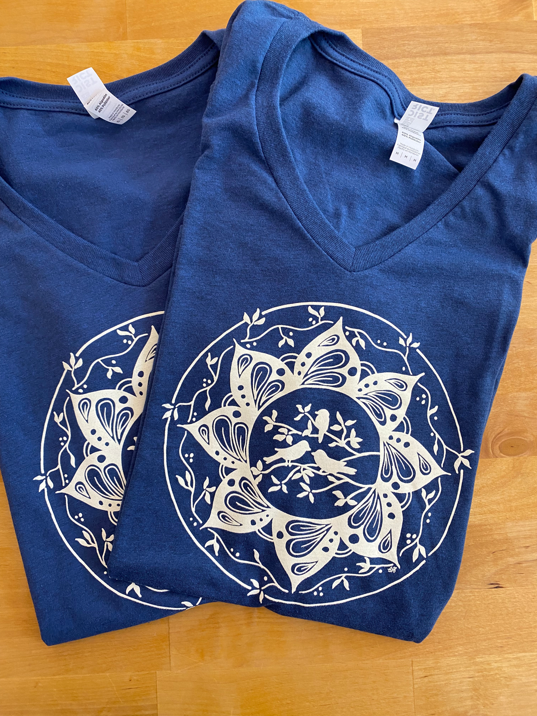 Women's Three Little Birds Mandala V-neck Tee (provides 12 meals)