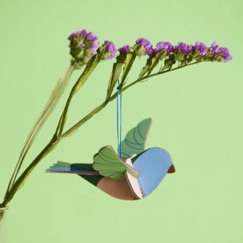 product photo bird ornament hanging from flower