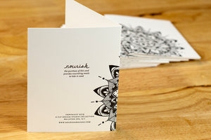 Propped card showing the back of the note card with a stack of cards behind 