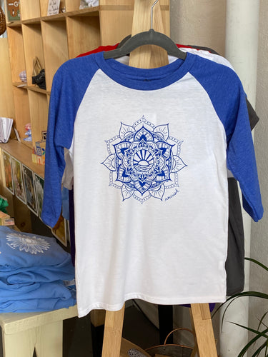 Product Image : Front View - Youth 3/4 sleeve white T-shirt with Blue sleeves with a large blue sun mandala design in the center