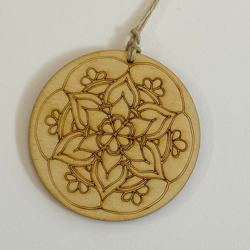 Wooden Color your own ornament. Circular shape with a flower shaped mandala design 