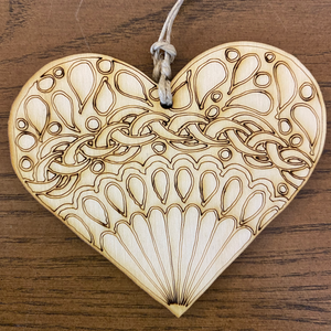 Product Image: Color your own wooden ornament. Heart shape with a fan style mandala design 