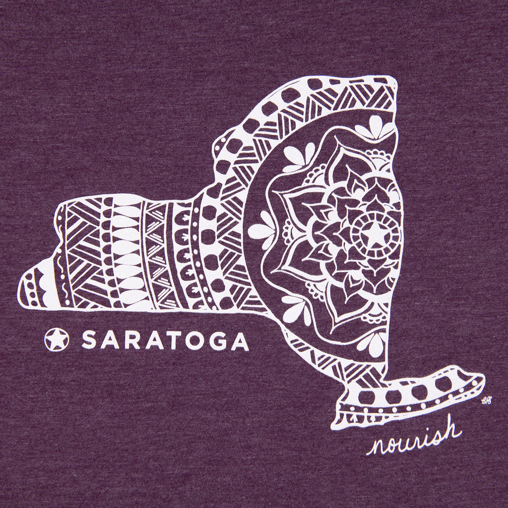 Close-up of the large white Saratoga Springs mandala design on eggplant. 